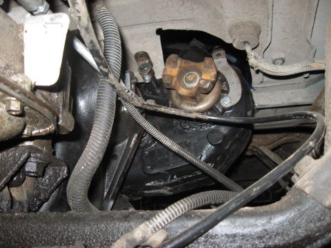 1991 Ford Bronco - Close-up of the vehicle's drivetrain components, including the transmission and driveshaft connection.