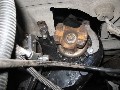 1991 Ford Bronco - Underside view of a vehicle's drivetrain, focusing on the transfer case and driveshaft connection.