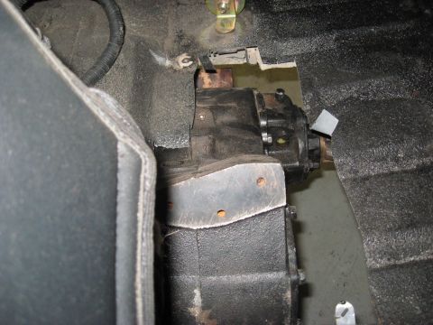 1991 Ford Bronco - Close-up view of a vehicle's transfer case, showing mechanical components and mounting hardware.