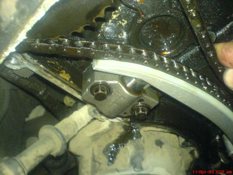 1992 Ford Crown Victoria - Close-up view of an engine's timing chain and tensioner mechanism.