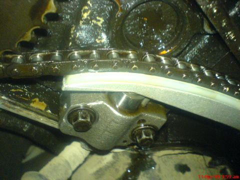 1992 Ford Crown Victoria - Close-up view of a timing chain and tensioner, likely within an engine compartment.