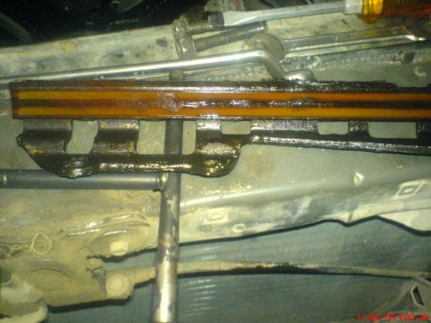 1992 Ford Crown Victoria - Close-up view of an engine timing chain guide, showing signs of oil residue and wear.