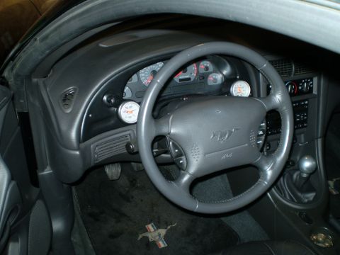 2002 Ford Mustang - Interior view of a 2002 Ford Mustang, a steering wheel and custom gauges.
