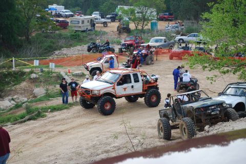 2008 Jeep Wrangler - A group of modified trucks and ATVs are seen at an off-road event.