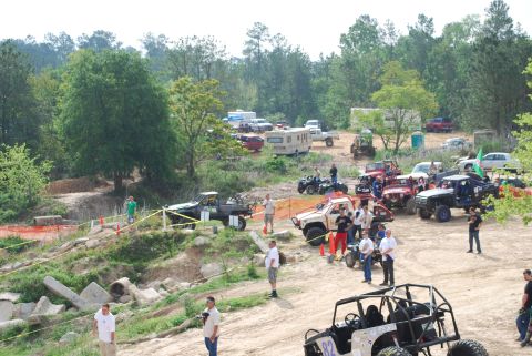 2008 Jeep Wrangler - An outdoor event with multiple off-road vehicles and spectators gathered in a wooded area.
