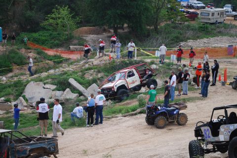 2008 Jeep Wrangler - Spectators watch as vehicles navigate a challenging off-road course.