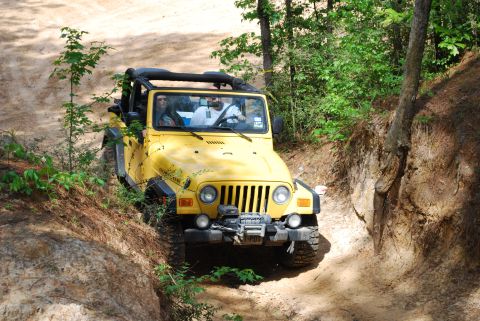 2008 Jeep Wrangler - A yellow 2008 Jeep Wrangler Rubicon navigates a challenging off-road trail.
