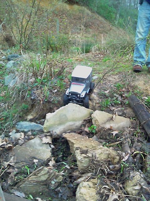 1996 Ford Bronco - A remote control rock crawler navigates a challenging, rocky path outdoors.