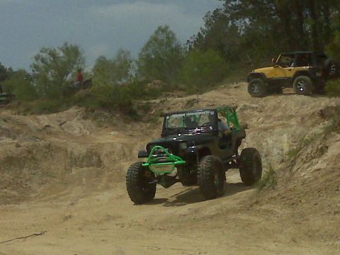 2008 Jeep Wrangler - Two Jeep Wranglers tackle an off-road course on a sunny day.