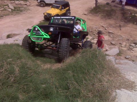 2008 Jeep Wrangler - A modified Jeep Wrangler navigates a rocky trail with another Jeep visible in the background.