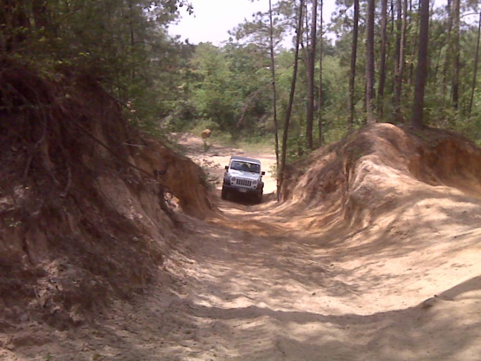 White 2007 Jeep Wrangler on a dirt trail
