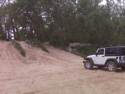 2008 Jeep Wrangler - White 2007 Jeep Wrangler on a sandy off-road trail.