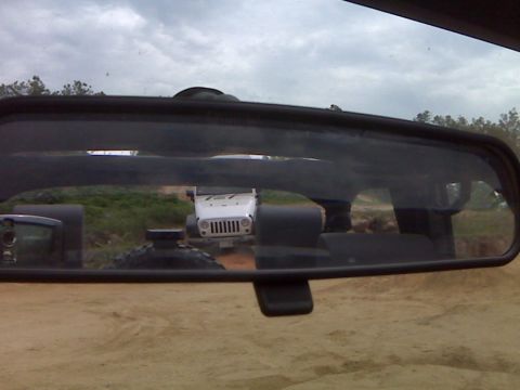 2008 Jeep Wrangler - A white Jeep Wrangler is visible in the rearview mirror of another vehicle.