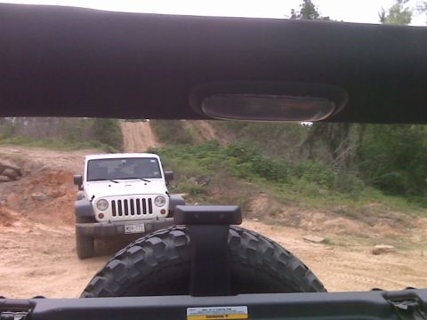 2008 Jeep Wrangler - Two Jeep Wranglers on a dirt trail, one white and one partially visible in the foreground.