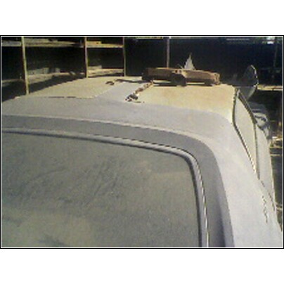 1973 Mercury Cougar - The top of a vehicle is shown, with some items placed on the roof.