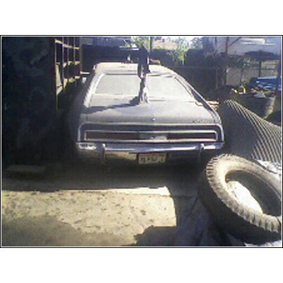 1973 Mercury Cougar - Rear view of a dusty 1973 Mercury Cougar parked outdoors.
