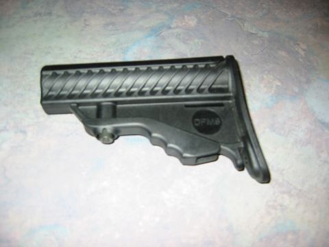 1996 Ford Bronco - A black gun stock part with a textured surface and a visible logo is shown against a mottled background.