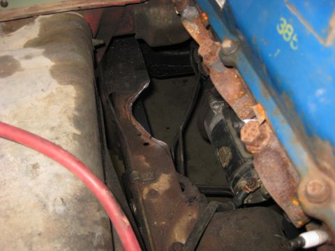 1979 Ford Bronco - Close-up of engine components including a starter motor and a blue manifold with visible '385' markings.