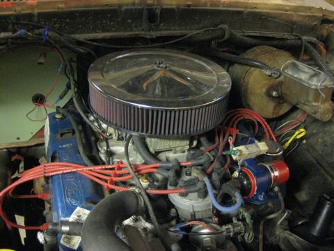 1979 Ford Bronco - Close-up of a Ford V8 engine, likely modified, showing the air intake and ignition system.