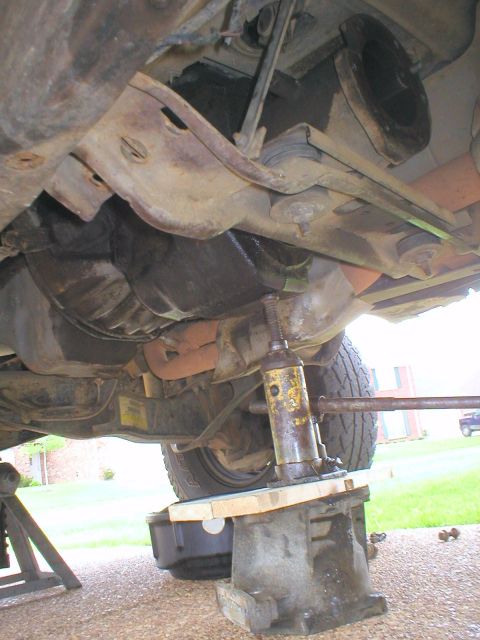 1983 Ford Bronco - With the weight off the crossmember and the two 3/4" transmission bolts removed, the crossmember can be slid backward and rotated out of th…
