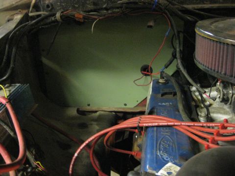 1979 Ford Bronco - Engine bay of a Ford truck with the inner fender and firewall area stripped and painted light green, showing a blue Ford valve cover stampe…