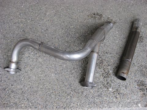 1979 Ford Bronco - Custom exhaust pipe and flex pipe components laid out on a concrete surface.