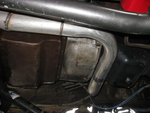 1979 Ford Bronco - Custom exhaust system routing near the transmission pan.