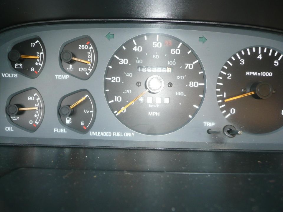 Dashboard with speedometer, tachometer, oil, fuel, temp, and volts gauges. Odometer shows 166896 miles