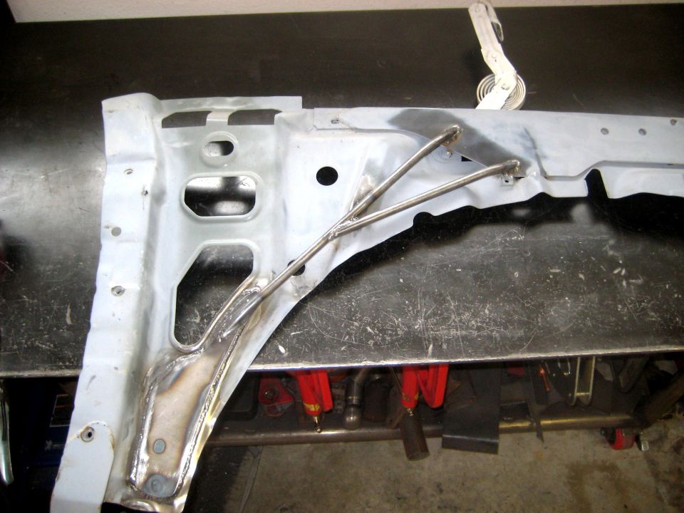 White radiator support panel on welding table with steel tube braces welded across it