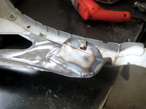 1996 Ford Bronco - A close-up view of a metal bracket that has been welded and appears to be a vehicle part.