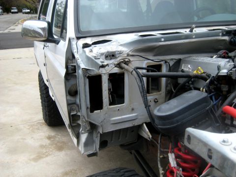 1996 Ford Bronco - White Ford Bronco parked in a driveway with the front fenders and hood removed, exposing the cowl, bare inner fender structure, wiring harn…