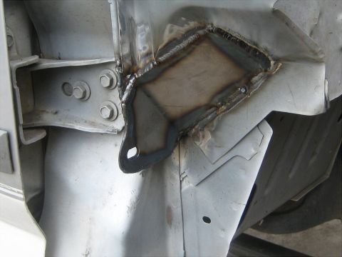 1996 Ford Bronco - Close-up view of a welded metal bracket attached to the vehicle's frame.