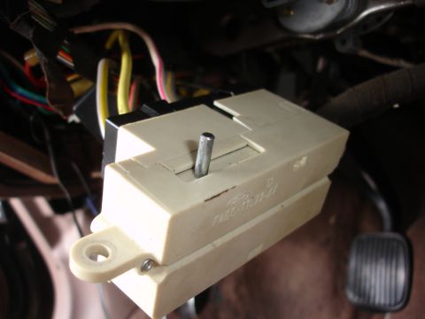 1995 Ford Taurus - The ignition switch actuator rod is shown in detail, with wiring harness components visible in the background.