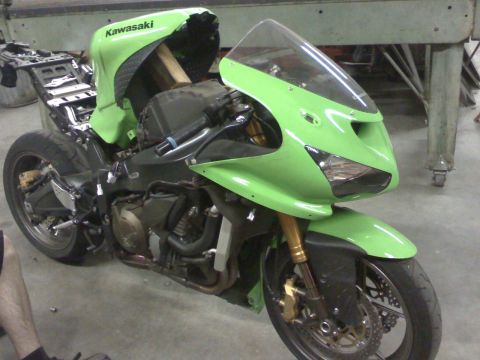 2005 Kawasaki Ninja R - A green Kawasaki Ninja R motorcycle is partially disassembled in what appears to be a workshop.