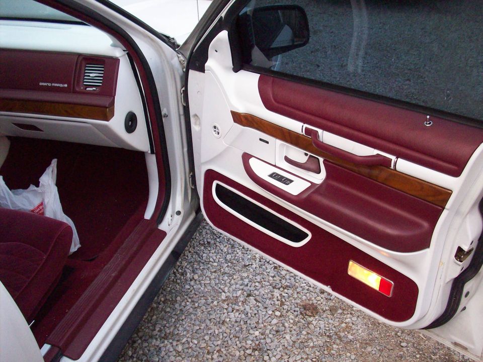1992 Mercury Grand Marquis interior door panel with maroon and white trim, wood accents, and power window controls