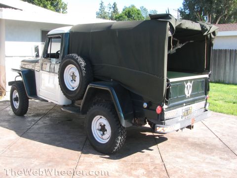 1968 Ford Mustang - This vintage Jeep Willys pickup truck features a distinctive two-tone paint scheme and a functional canvas bed cover.