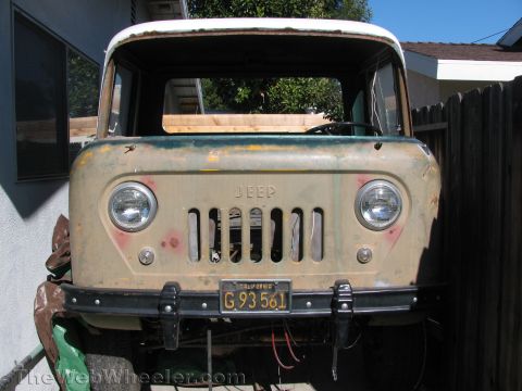 1968 Ford Mustang - This weathered Jeep truck, seen from the front, displays its iconic grille and round headlights, with a California license plate attached.