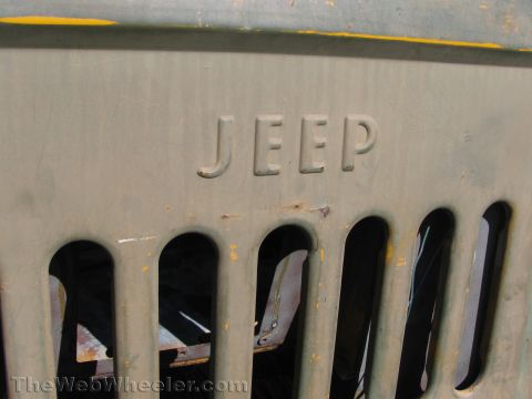 1968 Ford Mustang - Close-up of a vintage Jeep grille, showing the embossed brand name and vertical openings.
