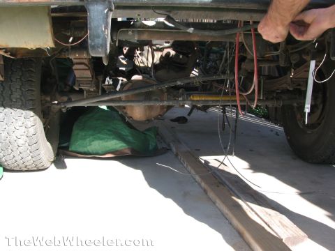 1968 Ford Mustang - A close-up view reveals the complex mechanical underpinnings of a vehicle, including the drivetrain and suspension systems.