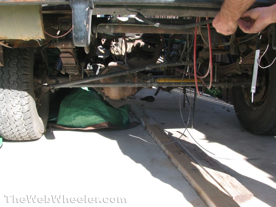 Underside view of vehicle with exposed drivetrain and suspension components