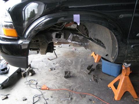 2004 Chevrolet Blazer - Front suspension components removed from a 2004 Chevrolet Blazer, showing the frame and wheel well.