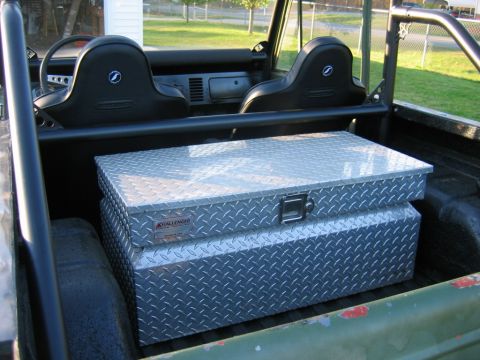 1992 Ford Mustang - Two diamond plate toolboxes are stored in the rear of a classic Ford Bronco.