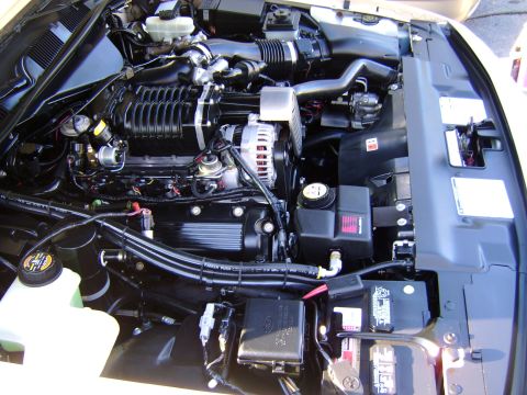1996 Mercury Grand Marquis - Close-up view of a modified engine bay, likely from a Ford Crown Victoria or Mercury Grand Marquis, a prominent supercharger.