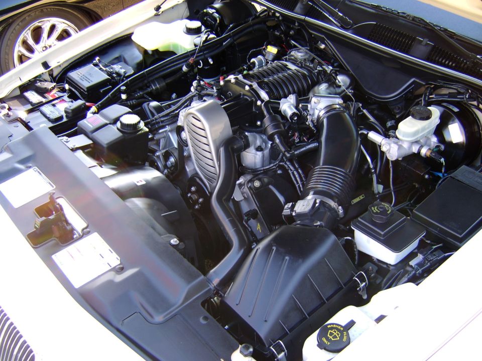 Engine bay with supercharged V8, air box, and master cylinder