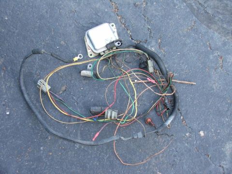 1985 Ford Crown Victoria LTD - A disassembled automotive wiring harness and voltage regulator are shown on the ground.