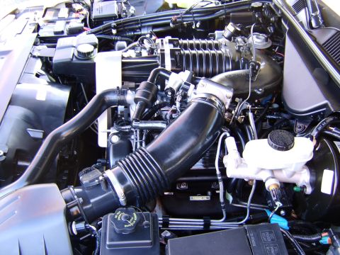 1996 Mercury Grand Marquis - Close-up view of a vehicle's engine bay, showing complex mechanical components and wiring.