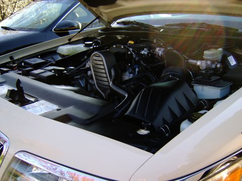 1996 Mercury Grand Marquis - The engine bay of a 1996 Mercury Grand Marquis is shown with the hood open.