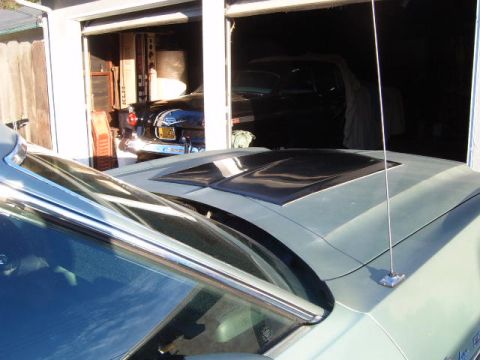 1973 Ford Ranchero - A 1973 Ford Ranchero is seen from the front, parked in a garage with another vehicle behind it.