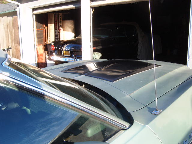 1973 Ford Ranchero hood with black scoops, parked in garage