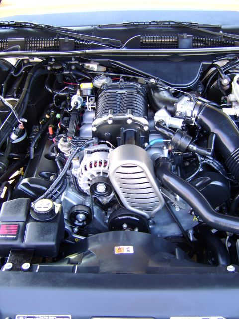 1996 Mercury Grand Marquis - Close-up view of a supercharged engine bay, highlighting the intricate components and wiring.
